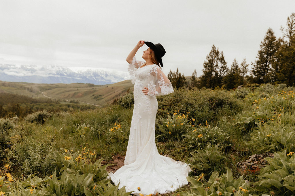 bridal portrait with a cowboy hat in a wildflower field