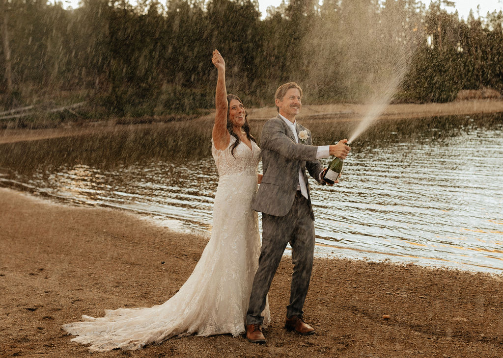 bride and groom popping champagne