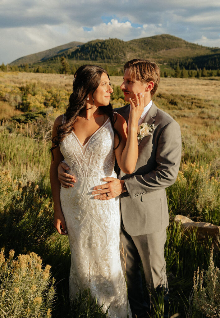 bride and groom in a wildflower field in colorado during their windy point campground wedding