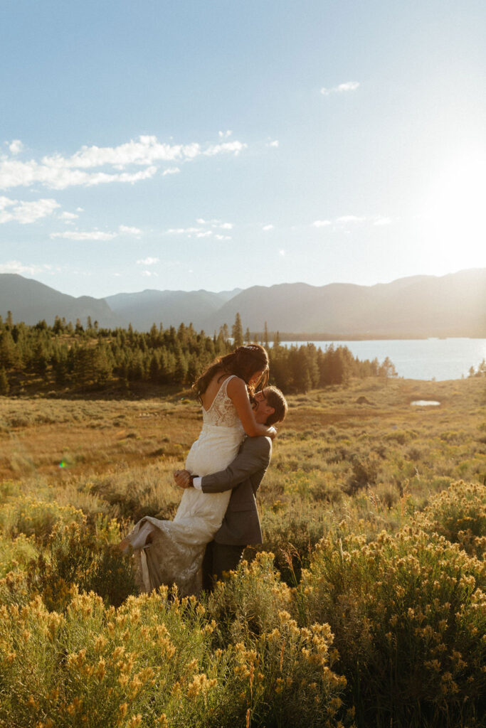 bride and groom in a wildflower field in colorado during their windy point campground wedding