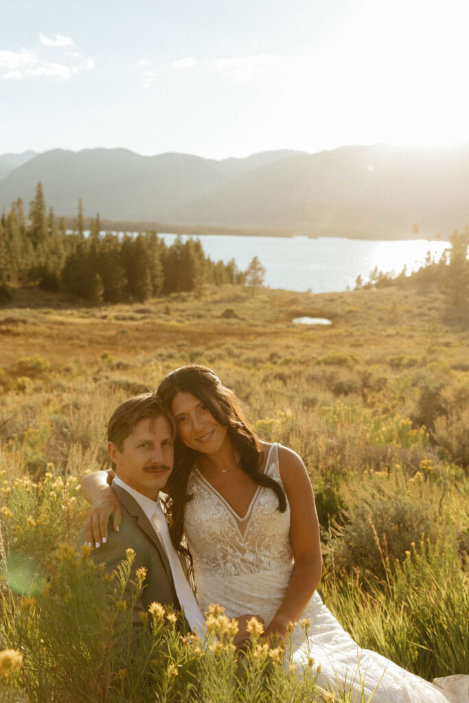 bride and groom in a wildflower field in colorado during their windy point campground wedding