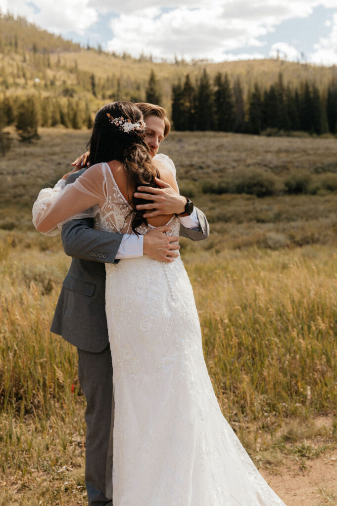 bride and groom first look in a vast open meadow