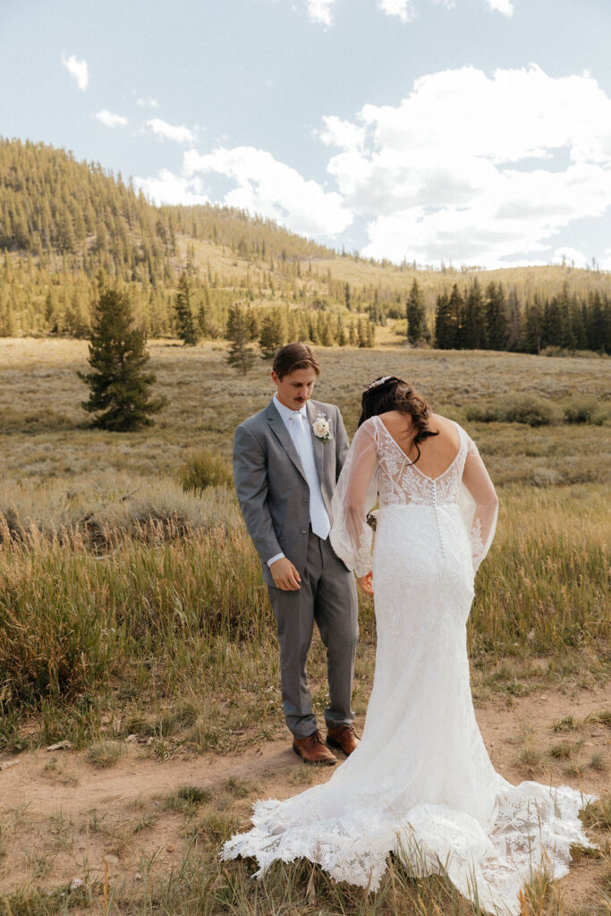 bride and groom first look in a vast open meadow