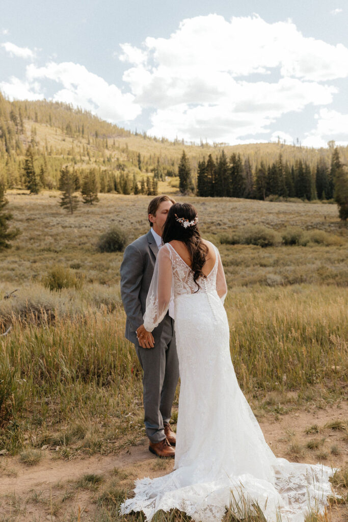 bride and groom first look in a vast open meadow