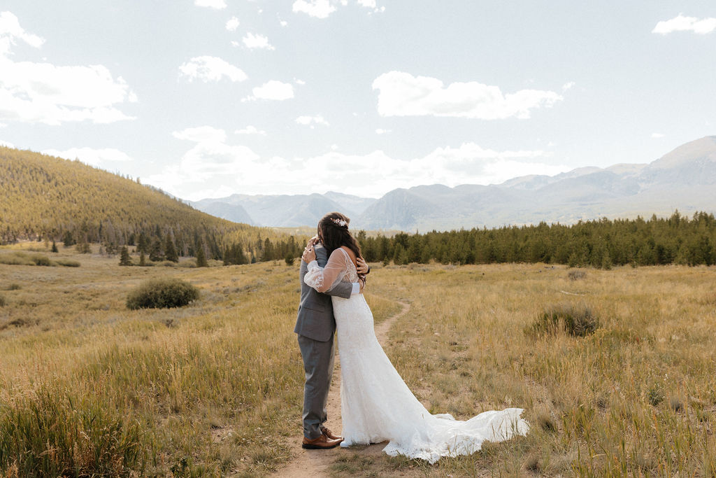 bride and groom first look in a vast open meadow