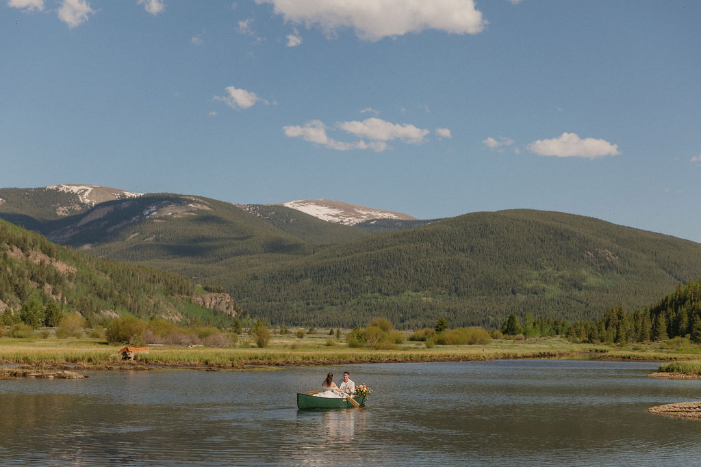 Camp Hale Wedding Venue photos of bride and groom in a canoe