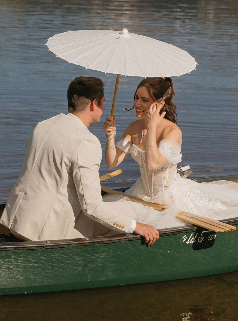 bride and groom in a canoe in the mountains in Vail, Colorado