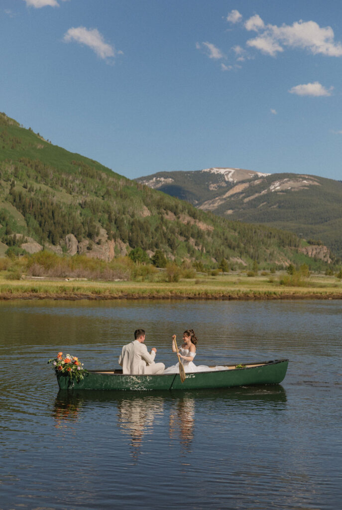 bride and groom in a canoe in the mountains in Vail, Colorado