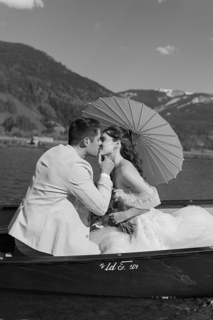 bride and groom in a canoe in the mountains in Vail, Colorado