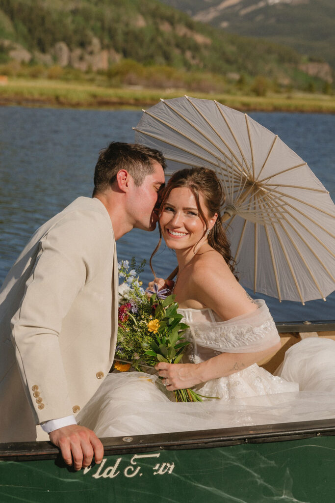 bride and groom in a canoe in the mountains in Vail, Colorado