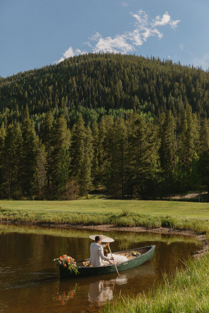 bride and groom in a canoe in the mountains in Vail, Colorado