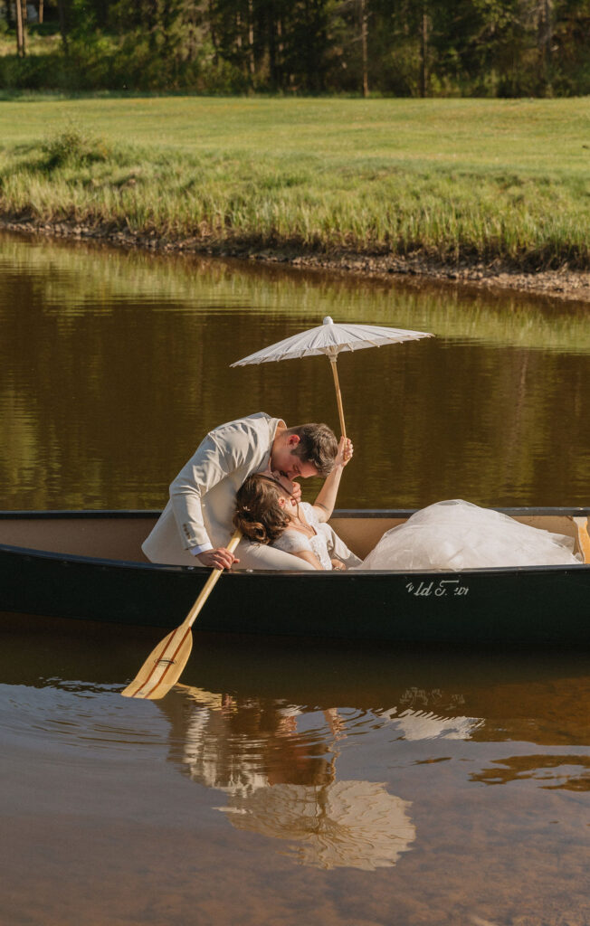 bride and groom in a canoe in the mountains in Vail, Colorado