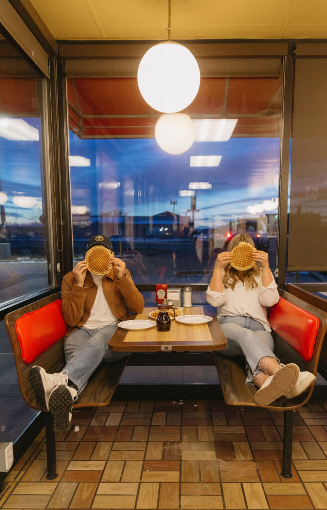 Unique engagement session date at Waffle House couple posing with waffles 