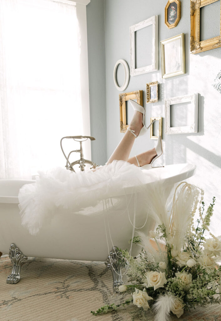 editorial bride in clawfoot bathtub at historic colorado wedding venue the manor house