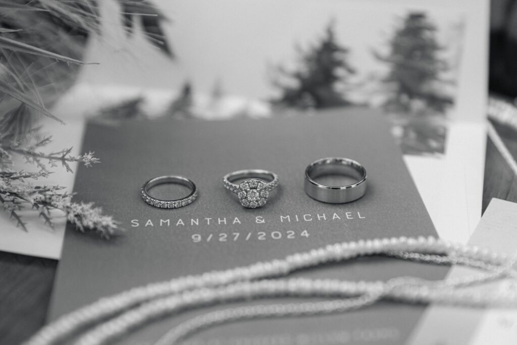 Up close black and white image of elegant wedding rings from a fall Colorado wedding at Crooked Willow Farms. 