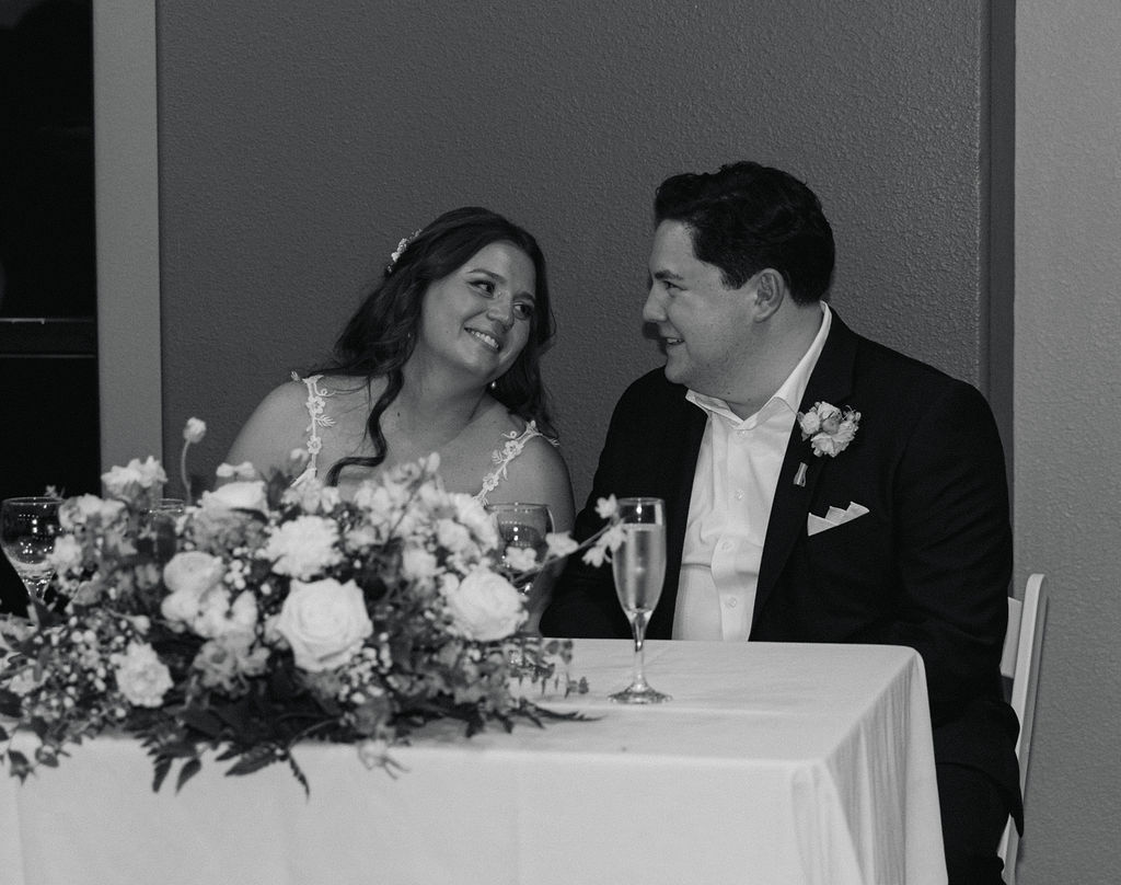 candid black and white moment of the bride and groom during the reception