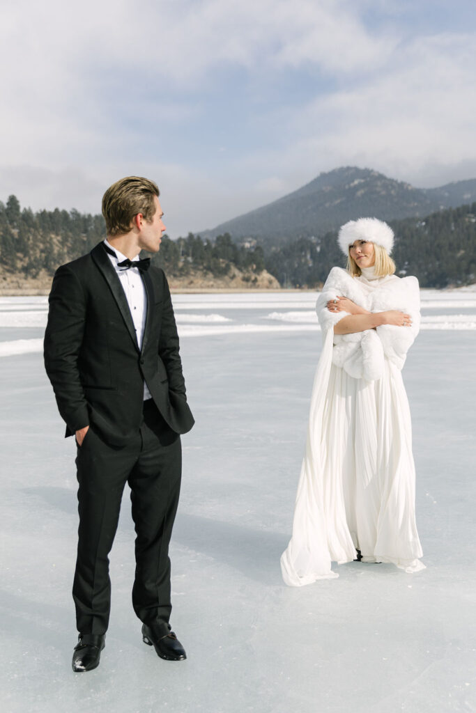 bride and groom surrounded by the colorado winter scenery at evergreen lake house 