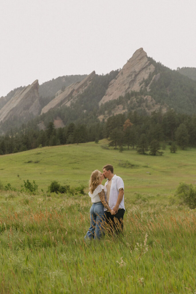 Post-rain engagement session with sunlight glistening on the field at top Colorado engagement location in Boulder