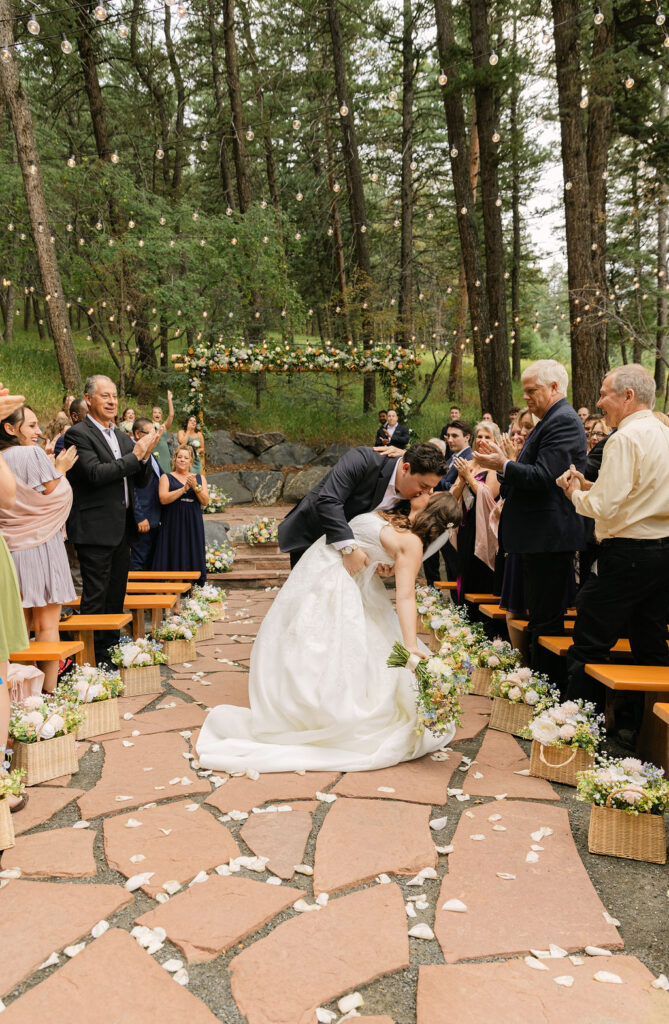 Forest wedding ceremony at The Pines by wedgewood weddings romantic first kiss in the aisle