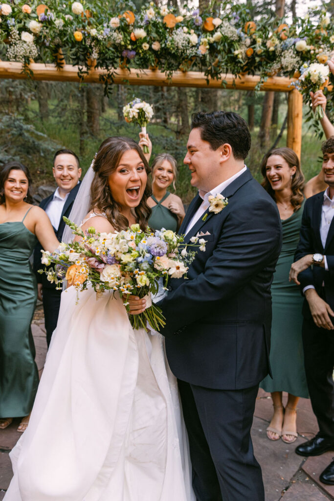 excited bride and groom and their wedding party during their dreamy woodlands wedding at the Pines by Wedgewood Weddings