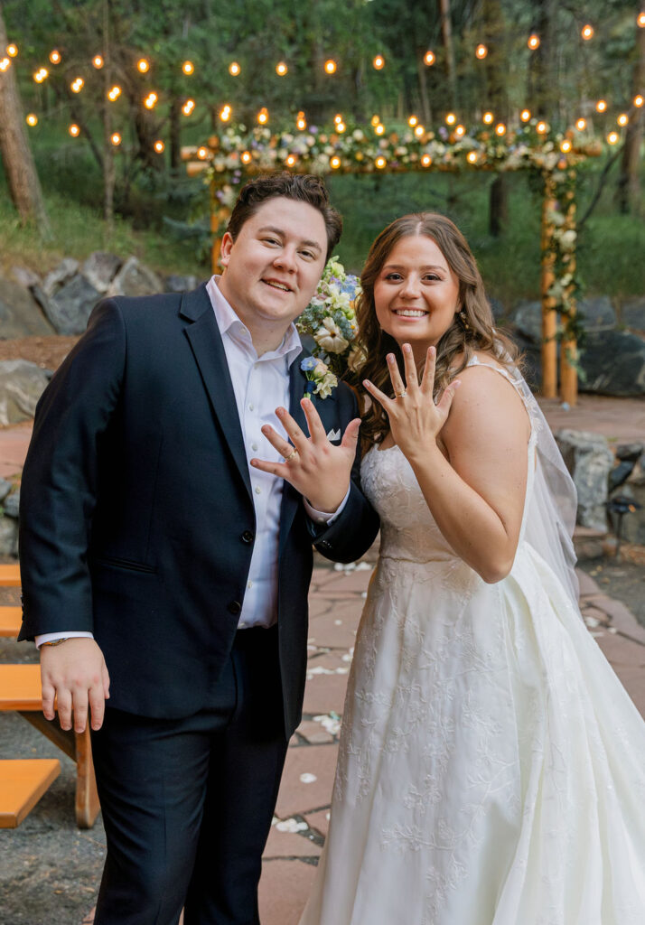 happy bride and groom posing at their ceremony space at The Pines by Wedgewood Weddings