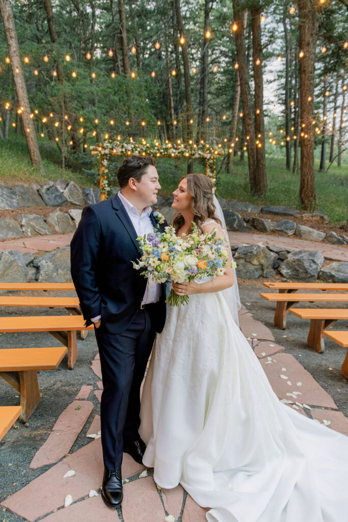 happy bride and groom posing at their ceremony space at The Pines by Wedgewood Weddings