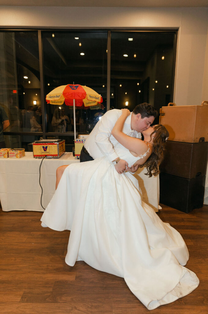 groom dipping his bride for a kiss