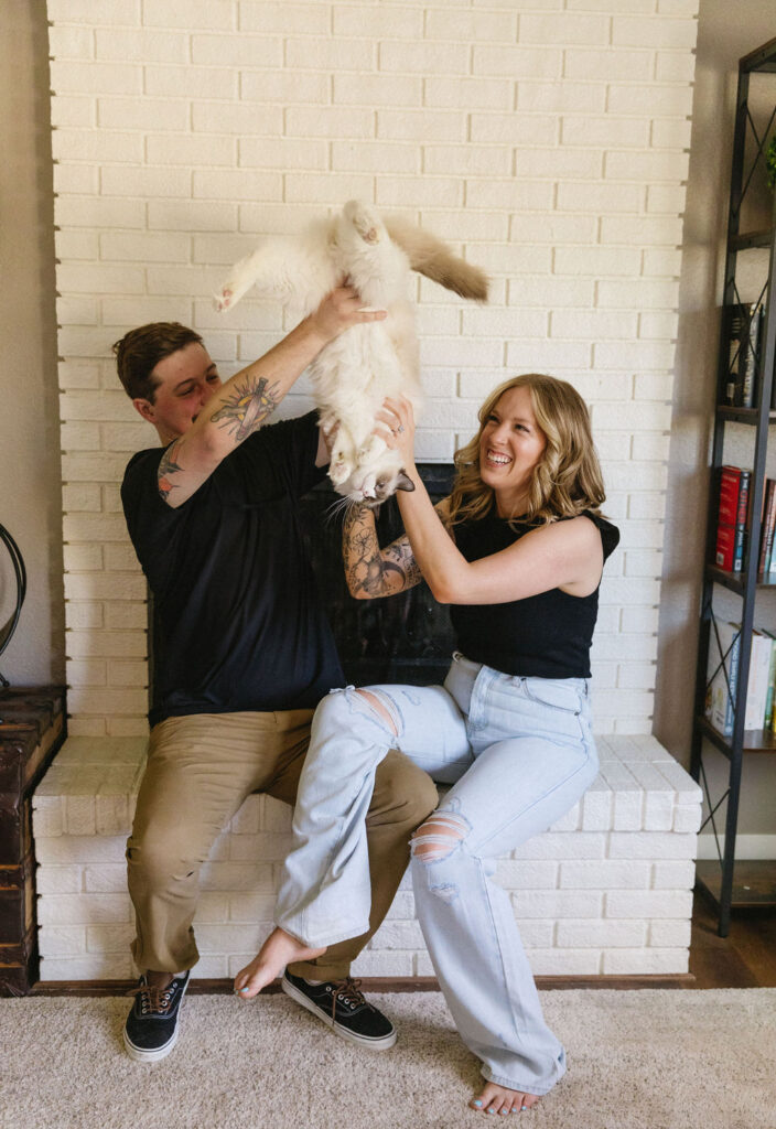 Playful in-home engagement photos with a cat.