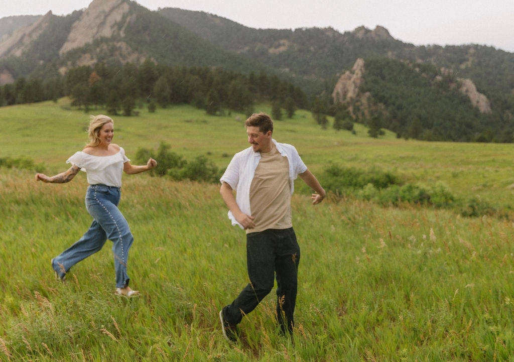 Sound of Music inspired pose with couple on Boulder hillside after rain shower