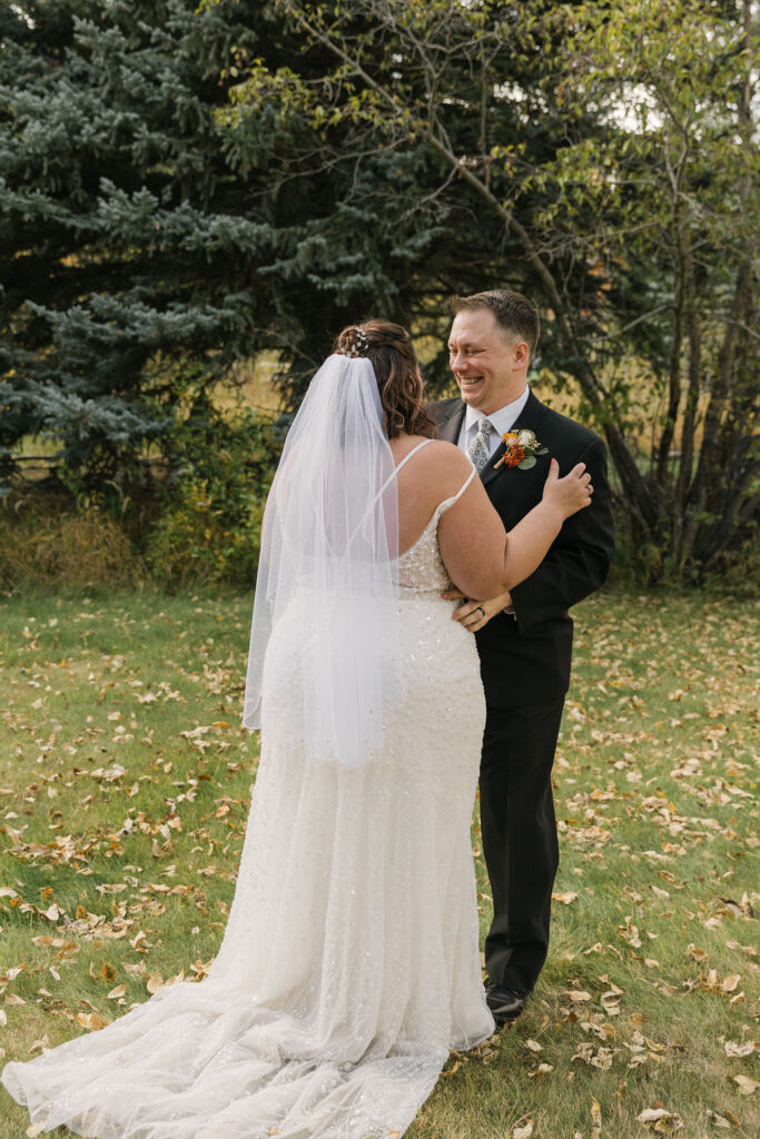 playful bride and groom exploring estes park during their elopement at the romantic riversong inn