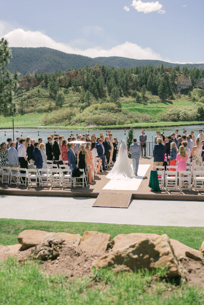 Bride walking down the aisle at her Perry Park Country Club wedding ceremony