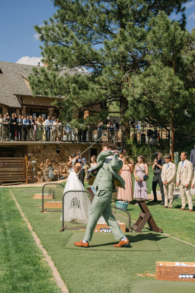 Bride and groom opening the driving range during cocktail hour at Perry Park Country Club