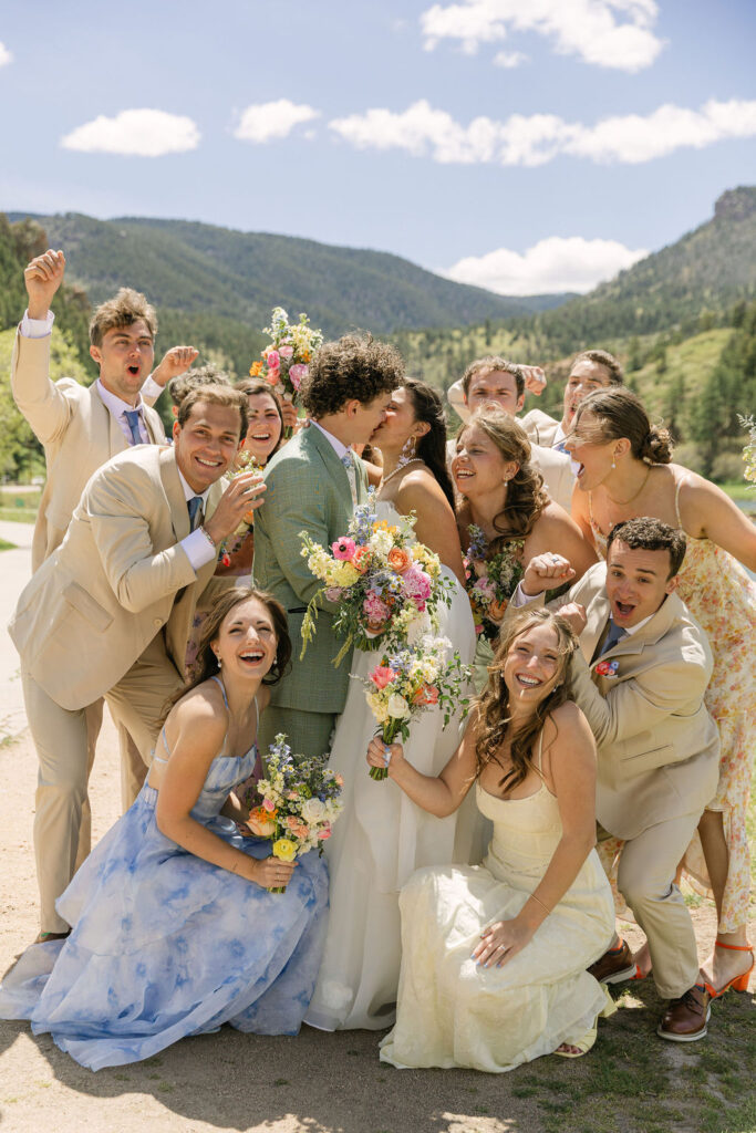 joyful bridal party with colorful wildflower bouquets and mismatched bridesmaid dresses in Larkspur Colorado