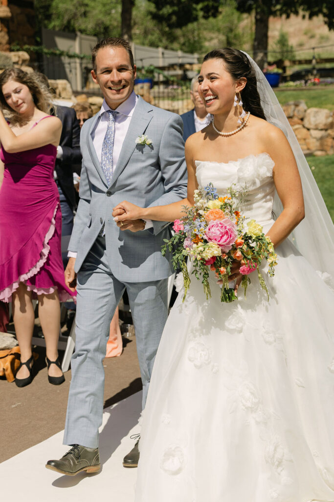 Bride walking down the aisle at her outdoor Colorado wedding