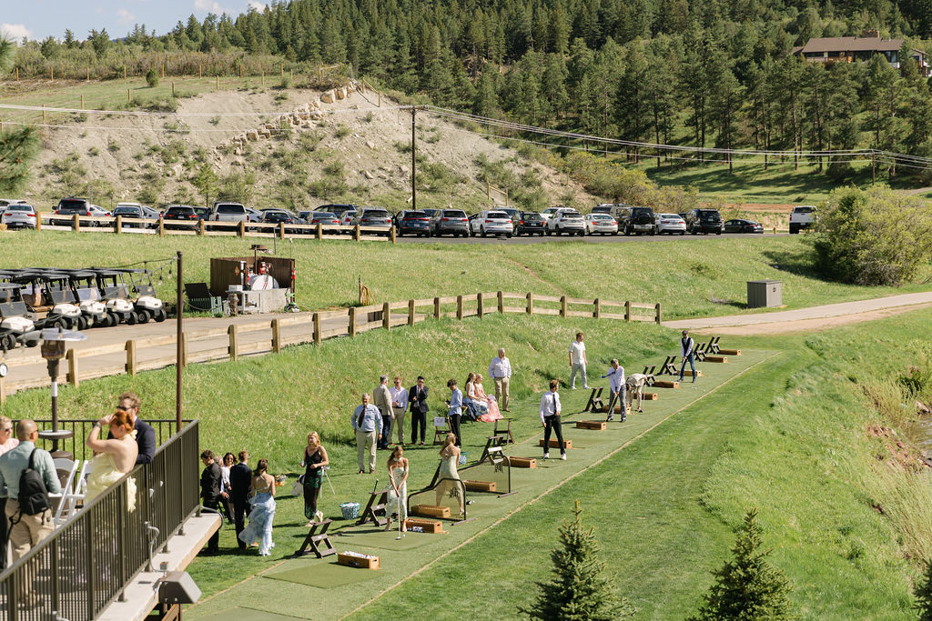 Unique Perry Park Country Club wedding cocktail hour with guests enjoying the driving range