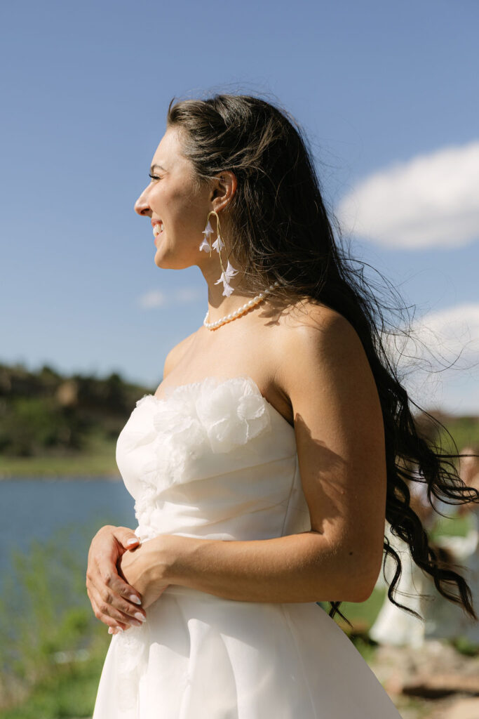 Elegant, editorial bride portrait with flowing hair and pearl jewelry by Lake Wauconda at Perry Park Country Club