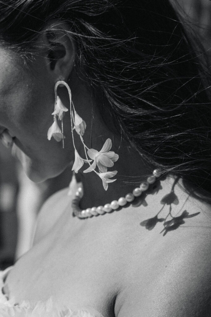 Artistic black and white detail shot of bridal jewelry and floral hair accessories at Perry Park Country Club wedding
