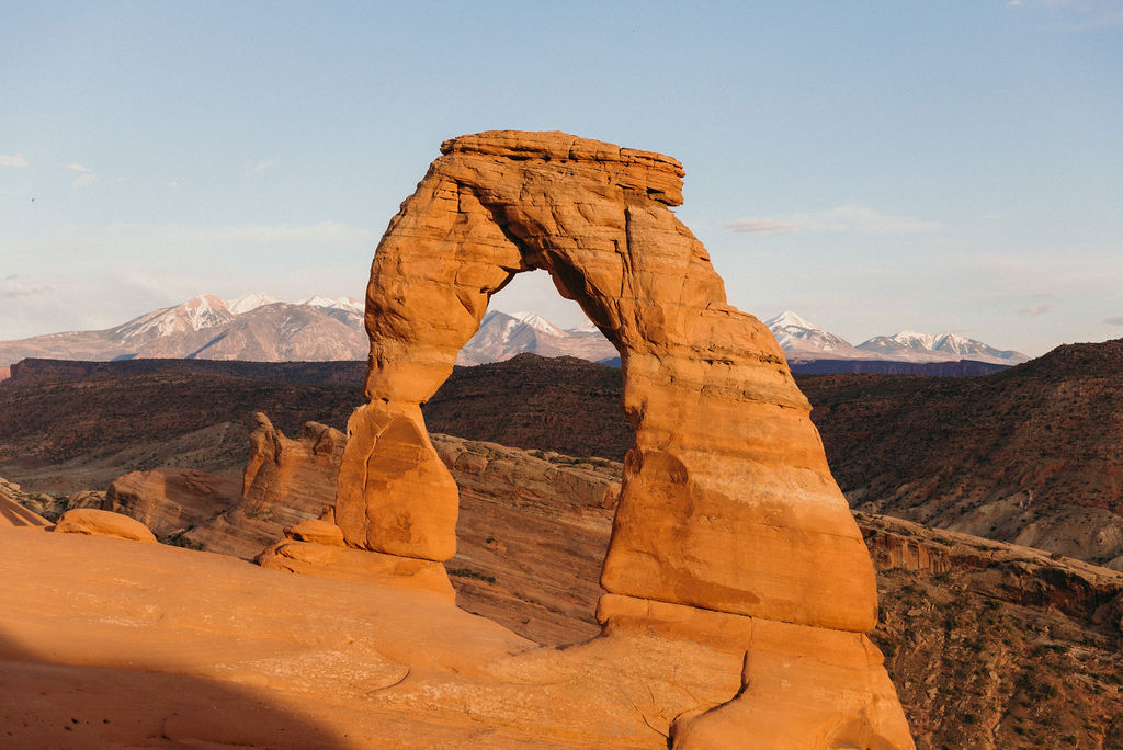 Golden hour light hitting Delicate Arch in Arches National Park—an unforgettable backdrop for adventurous couples getting married in Moab, Utah.