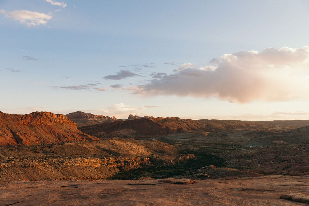 Panoramic view of Moab’s canyonlands at sunset, highlighting the dramatic terrain and wide-open skies that make Moab wedding venues so unique and stunning.