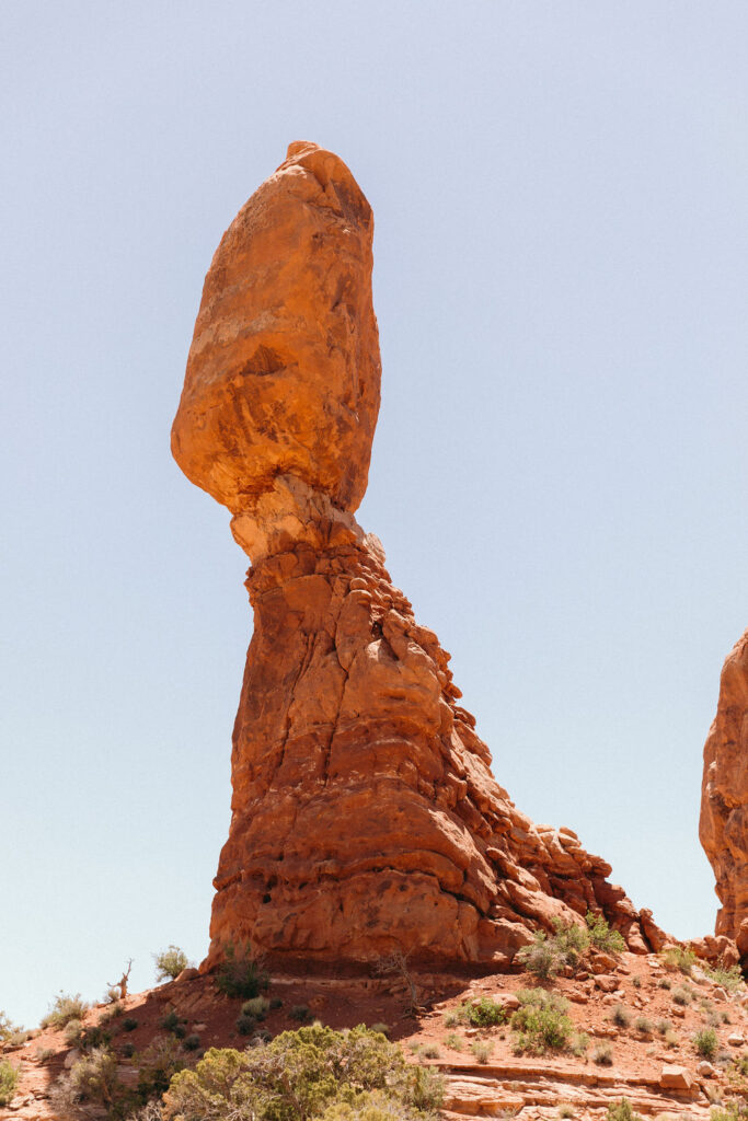 Balanced Rock in Arches National Park under a clear blue sky — a popular landmark near many Moab wedding venues known for its unique red rock formations.