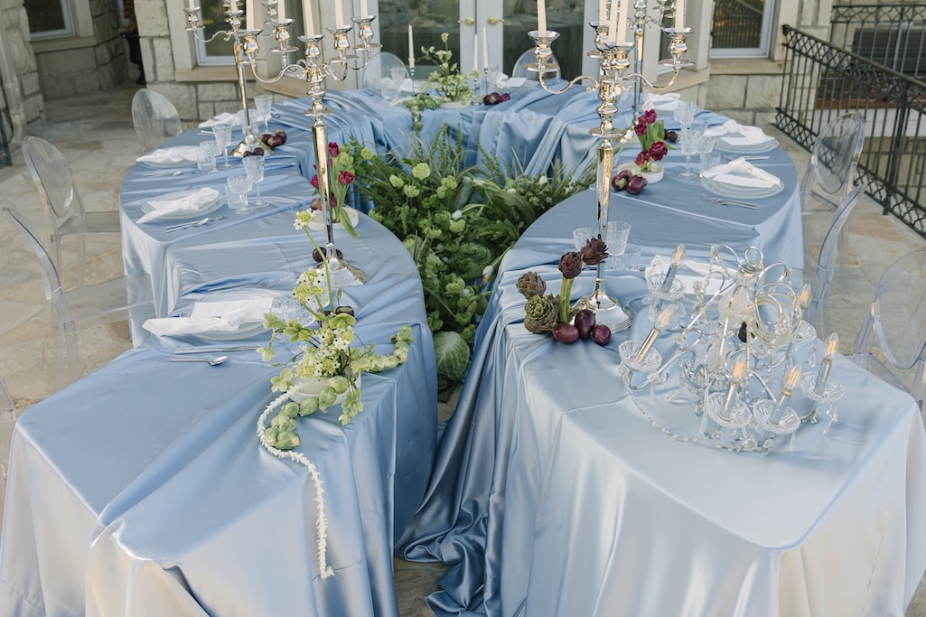Serpentine reception table design at Greystone Castle Boulder with unique fruit and vegetable florals
