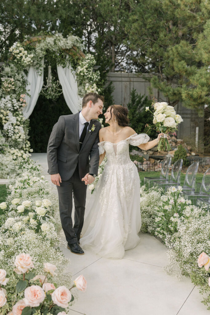 joyful bride and groom walking the aisle at the end of the ceremony, as they celebrate their wedding at Chateaux at Fox Meadows