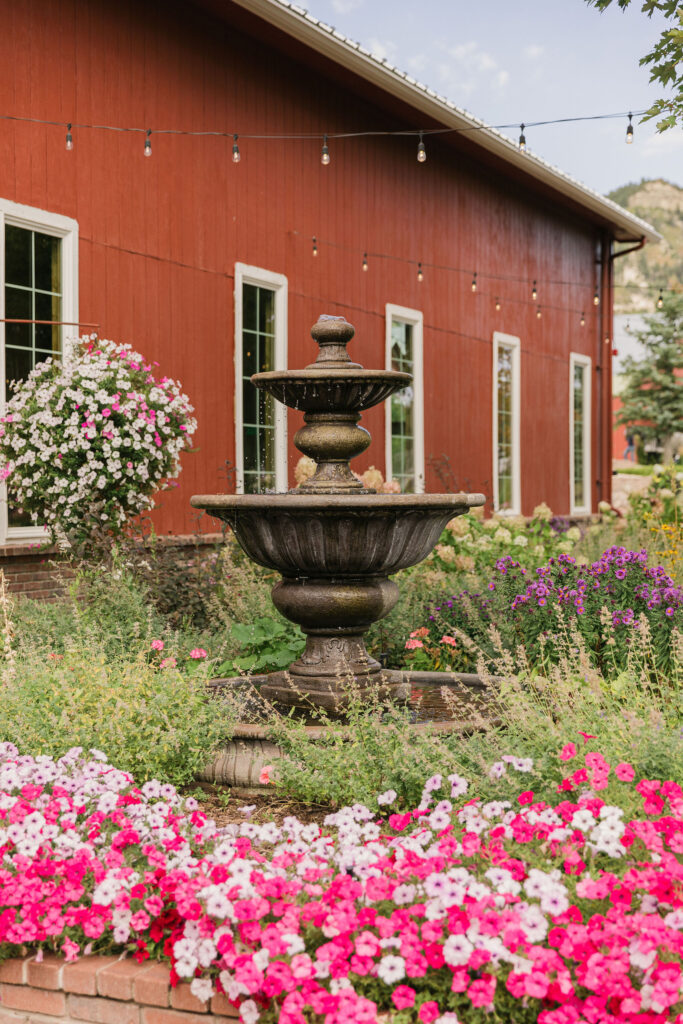 a vintage fountain set in front of the Venue at Crooked Willow Farms