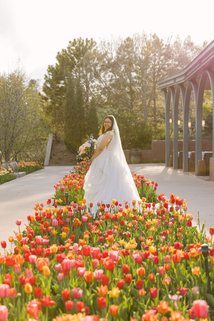 bridal portrait surrounded by colorful tulips at a garden wedding venue in Colorado
