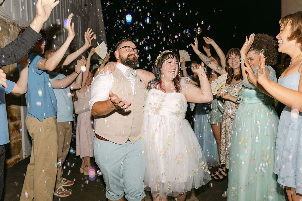 joyful and candid bride and groom wedding exit