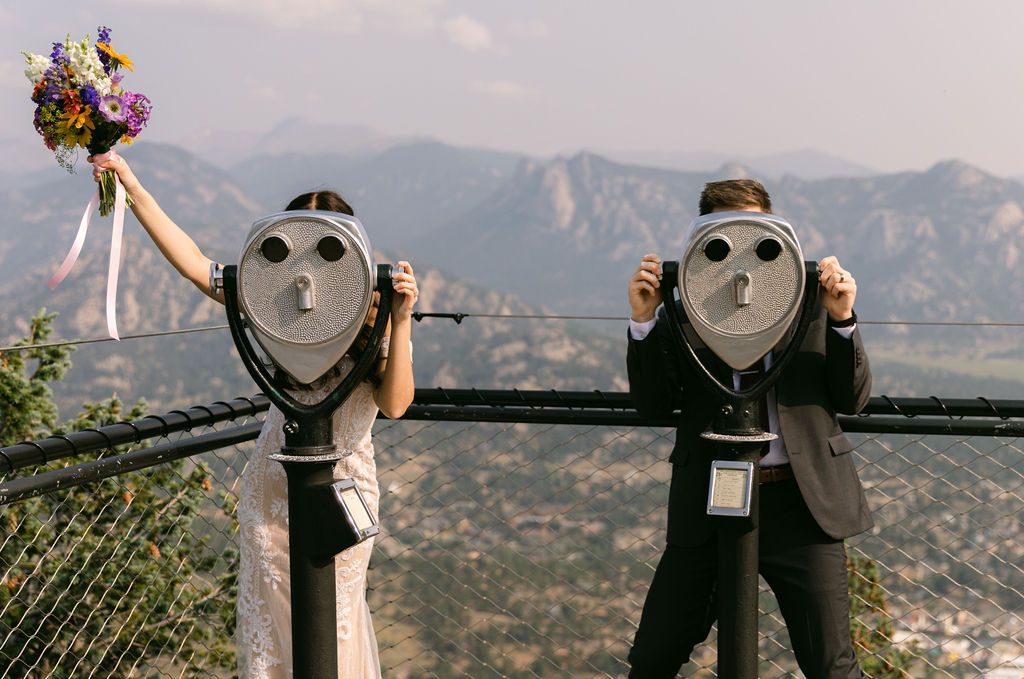 bride and groom looking through binoculars