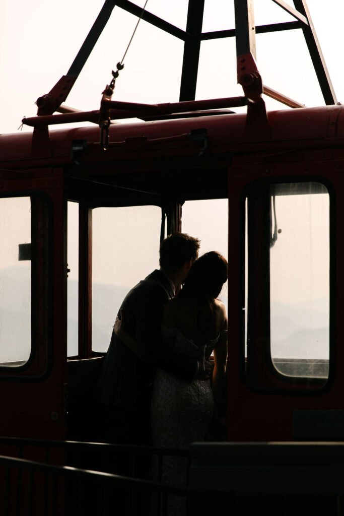 romantic bride and groom inside Estes park aerial tram