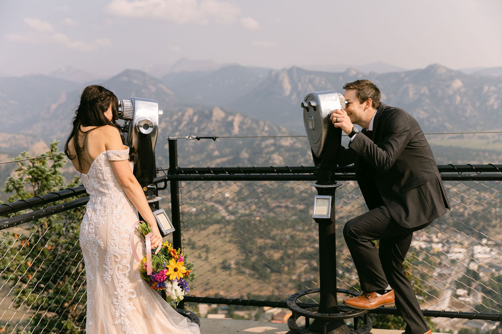 bride and groom looking through binoculars