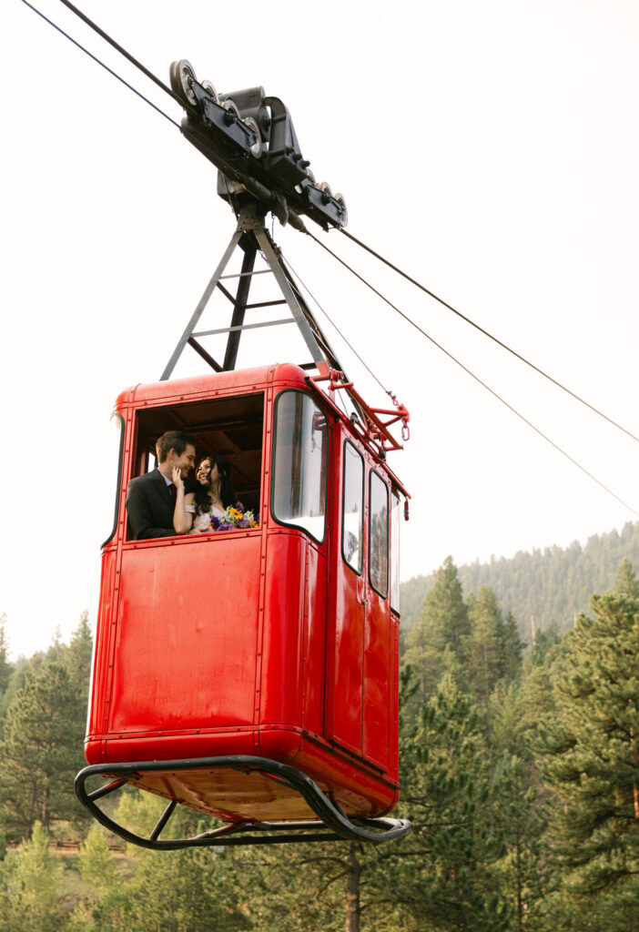 romantic bride and groom inside a Estes park aerial tram