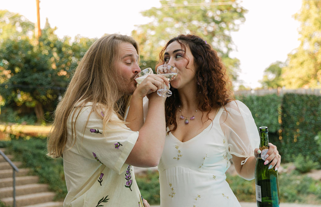 bride and groom drinking champagne
